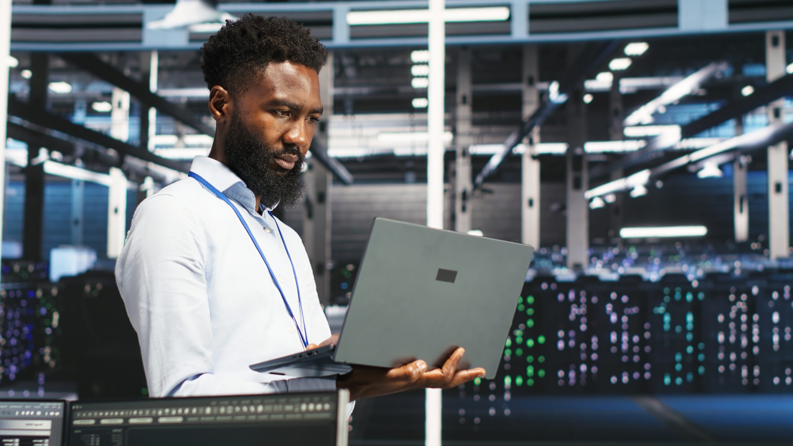 Data center programmer uses node tree software to identify equipment performance issues. African american server farm worker reviews data analysis graph to minimize hardware failures, camera B
